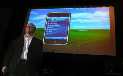 Jason Grigsby stands in front of the big screen demo of the Obama '08 iPhone application at the Mission Theater in Portland. It's my computer, which is why you see my name in the top right corner and a photo of mine as the background.