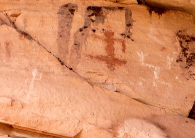 Detail of pictographs. These images seem to correspond to a key in the book "Rock Art Symbols of the Greater Southwest" (by Alex Patterson). They closely match symbols for a warrior or victorious hunter (left figure in red) and a dead/vanquished "headless" figure (white, upside down). But this is just a guess by a complete neophyte. 