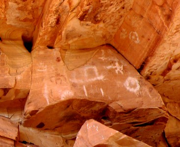 More detail. Some of these are clearly handprints. The hat-shaped symbol might be a cloud. Another warrior figure. The circle-with-a-dot could indicate several things, including an enclosure or (euphemistically) a female symbol.